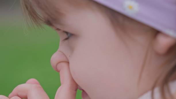 istock Young Caucasian Girl Picking Nose with Index Finger Front 1473794160
