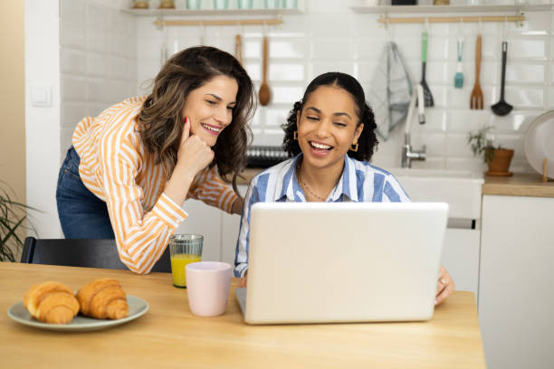 istock Two young women having a breakfast and freelancing from home office 1473798511