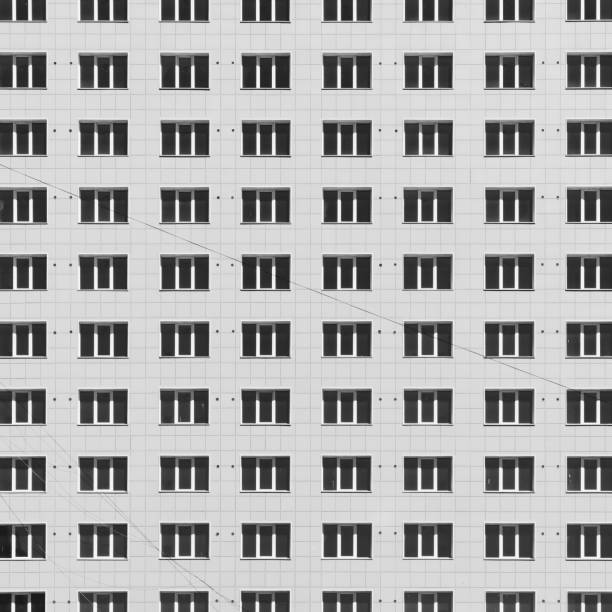 istock Geometric backdrop with lots of window rows. Simple classic design high-rise building. Realistic concept of office building. Apartment house texture background. Many windows on big wall close-up. 1473798833