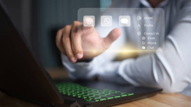 istock Businessman using computer laptop and touching on virtual screen contact menu email, phone, and live chat, chat with bot, 1473799543