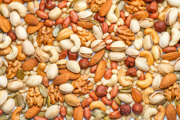 istock Background from different types of nuts and seeds 1473799646