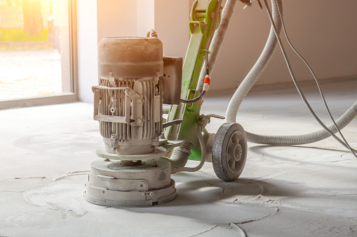 Grinding concrete industrial floors, lots of dust when grinding concrete with large professional grinders.