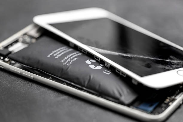 Swollen lithium-ion battery, modern smartphone, broken smartphone, battery-powered explosive electronics