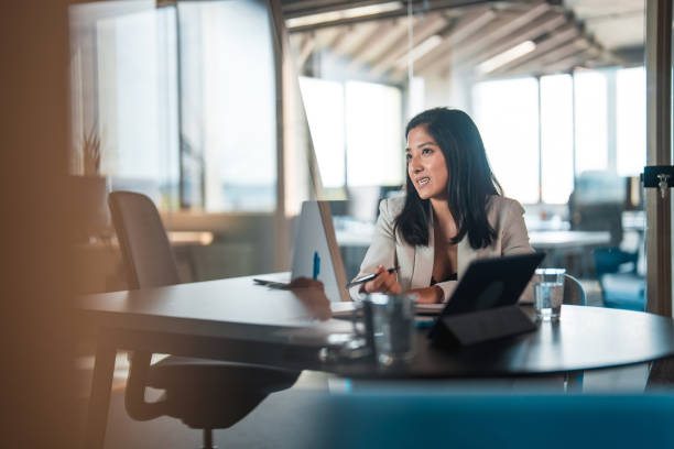 istock Young Woman Explaining Ideas During a Meeting 1473800069