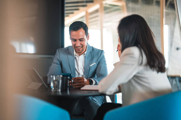istock Two Asian Colleagues Talking Business 1473800071
