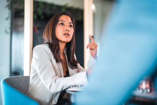 istock Serious Japanese Woman During Work Meeting 1473800075
