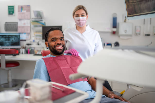 istock Happy Patient And His Professional Dentist 1473800912