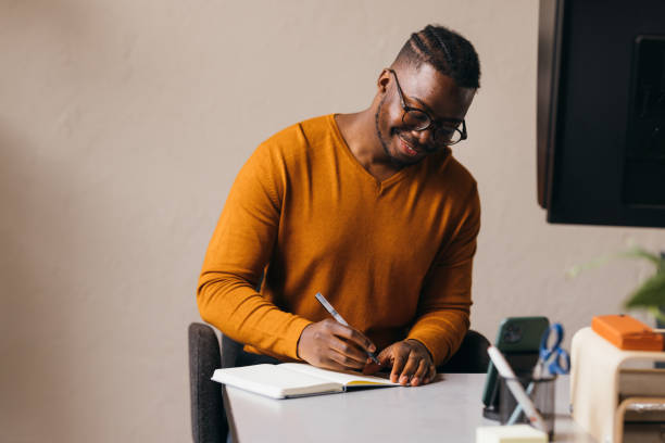 istock A Happy Businessman With Glasses Taking Some Notes In His Notebook 1473801243