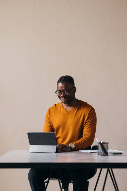 istock A Happy Businessman With Glasses Working On His Tablet 1473801275