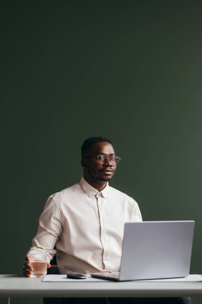 istock A Serious Businessman With Glasses Looking At Camera While Working On His Computer 1473801289