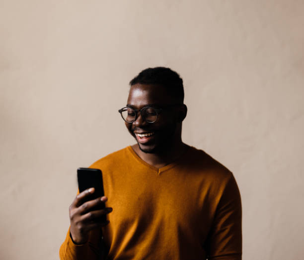 istock A Happy Businessman With Glasses Using His Mobile Phone 1473801291