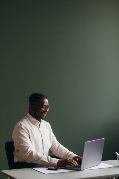 istock A Happy Businessman With Glasses Working On His Computer In The Office 1473801296