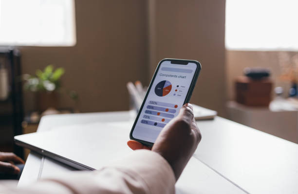 istock A Close Up View Of An Unrecognizable Businessman Using His Mobile Phone While Working In The Office 1473801306
