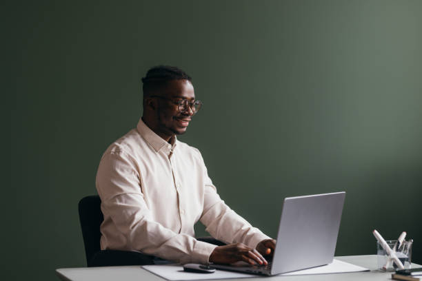 istock A Happy Businessman With Glasses Working On His Computer In The Office 1473801309