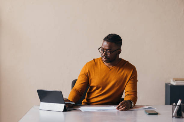 istock A Serious Businessman With Glasses Working On His Tablet 1473801315