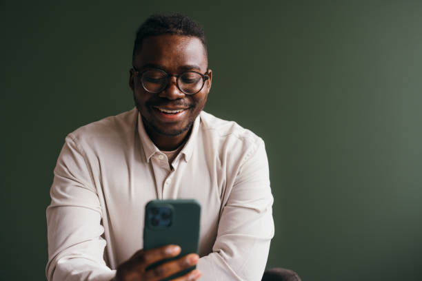 istock A Smiling Businessman With Glasses Using His Mobile Phone While Working In The Office 1473801321