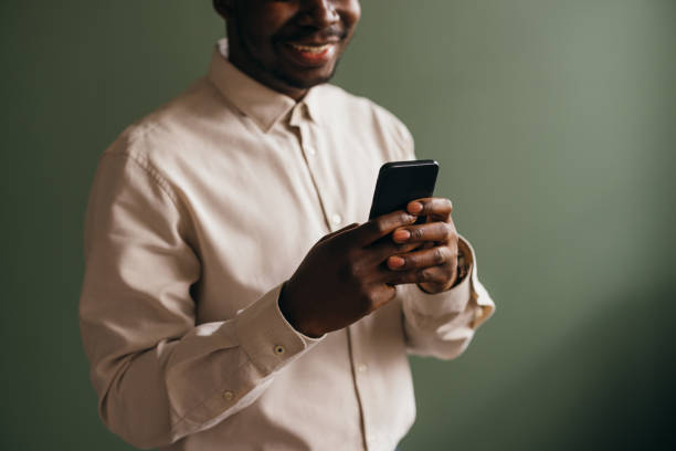 istock An Unrecognizable Happy Businessman Using His Mobile Phone 1473801334