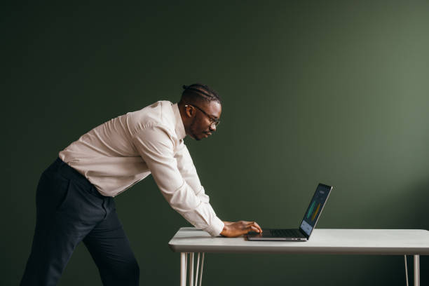 A Pensive Businessman With Glasses Working On His Computer In The Office