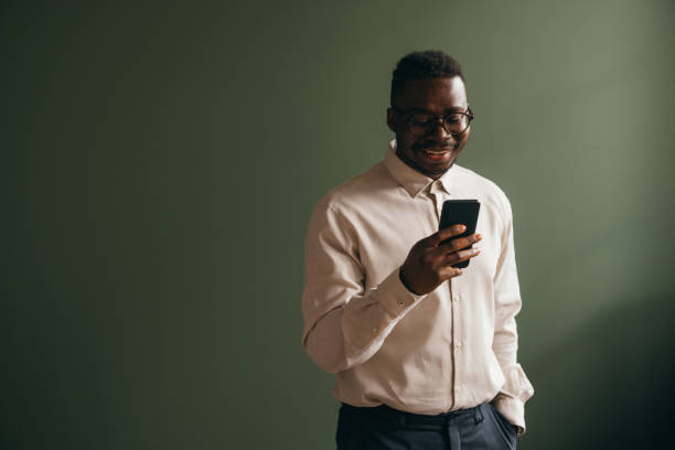 istock A Happy Businessman With Glasses Using His Mobile Phone 1473801356
