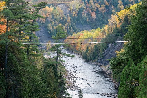 One of two suspension bridges spanning the depths of the Canyon Sainte-Anne. Autumn at Quebec. Canada.
