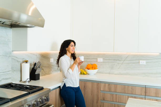 istock Relaxed woman enjoying coffee in the luxury kitchen 1473806970