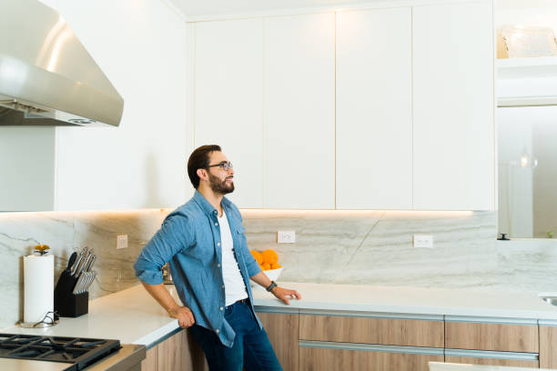 istock Happy handsome man enjoying his luxury kitchen 1473807028