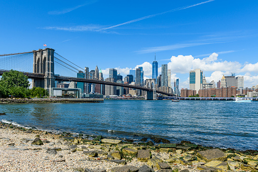 Brooklyn Bridge above the East River in front of the Manhattan skyline