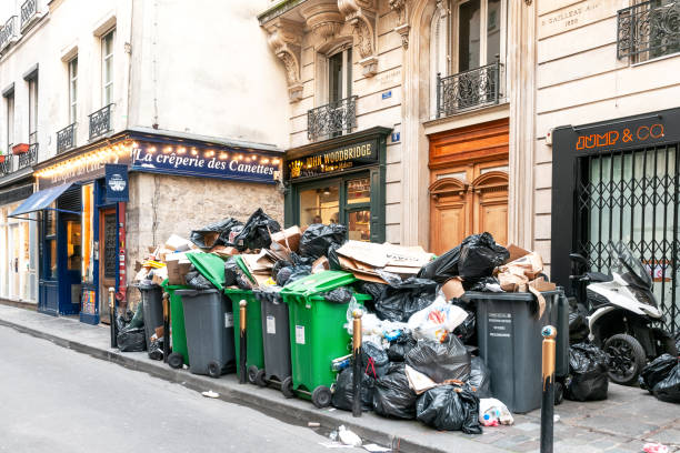Grève des éboueurs : Full garbage bins during a waste collection strike in Paris, in the chic 6th arrondissement, rue des Canettes, famous for its small restaurants - Neat Saint Germain des Près, Paris in France. March 15, 2023.