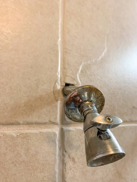 istock Hole cut into tile with a shower head protruding after installation. 1473819115