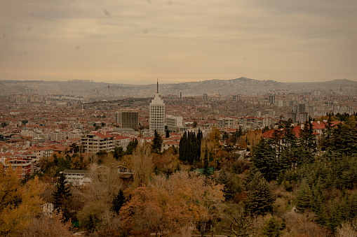 11/19/2021, Ankara / Turkey. Aerial view of Ankara city. Buildings, woodlands, and the sky are visible. Cloudy weather.