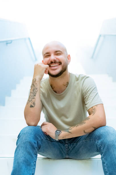 istock Portrait young man sitting on step of staircase 1473825265
