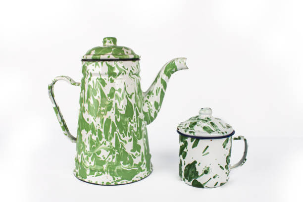 istock Green white teapot and small cup 1473825644
