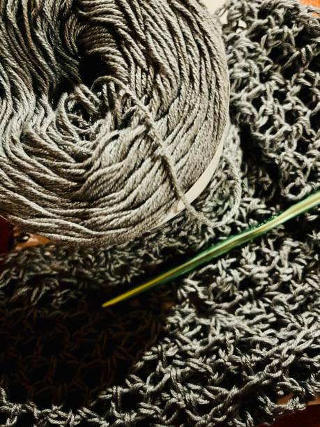 Grey crochet project with yarn and hook