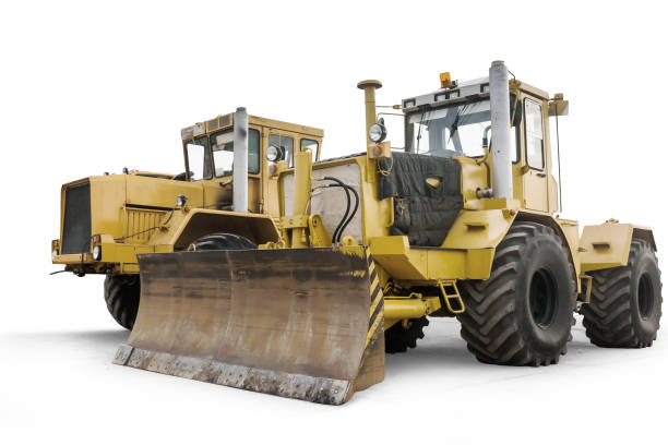 istock Two yellow heavy wheeled tractors isolated on white background 1473833774