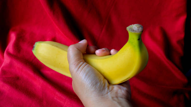 istock Hand holding banana 1473833827