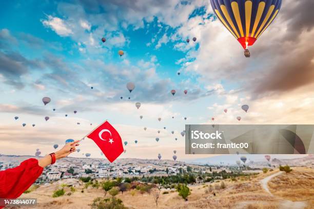 Experience The Beauty And Culture Of Turkey Through The Eyes Of A Young Woman As She Watches The Hot Air Balloons Of Cappadocia Soar And Displays The Turkish Flag Stock Photo - Download Image Now