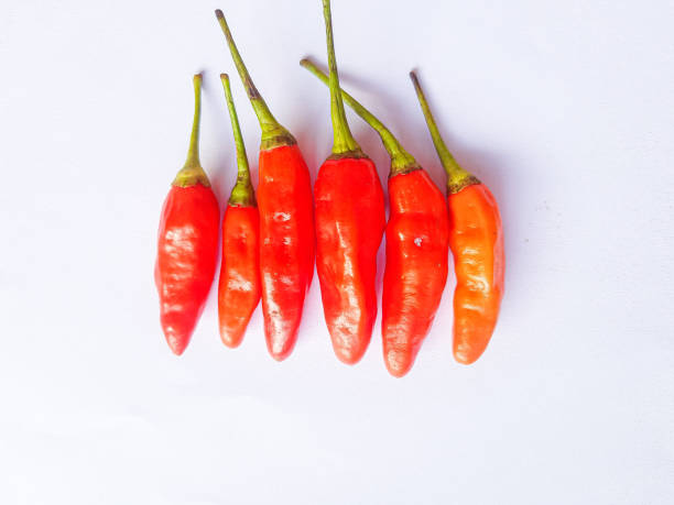 istock Red cayenne pepper. Red Cayenne pepper isolated on white background 1473844218