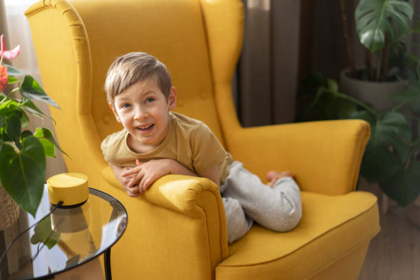 istock A little boy sits in a chair and communicates with a smart speaker 1473845245