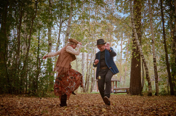 Dancing couple in a bright autumn park