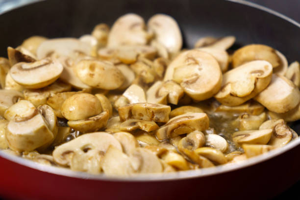 istock Mushroom champignon soup is cooked. Mushrooms are boiling close-up. 1473846736