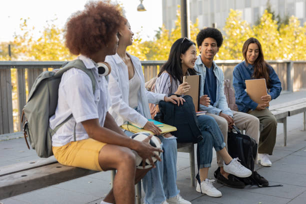 istock group of multiracial classmates meeting on campus at break - exchange students - 1473847764