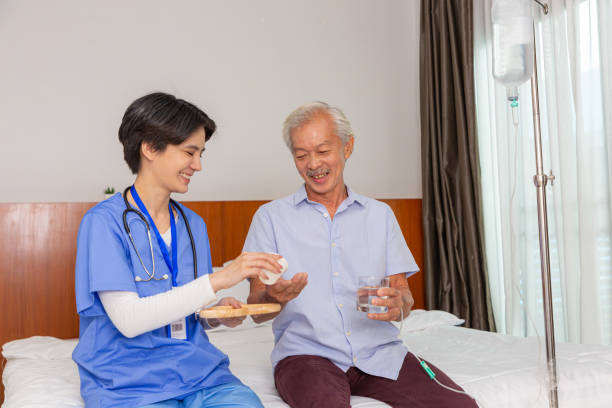 istock Senior man eats pills before lunch at retirement home. 1473849299