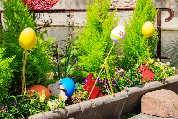 Flowerbed with flowers and Easter decoration at spring