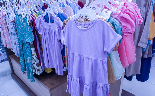 Display of kid clothes and dress at clothing store
