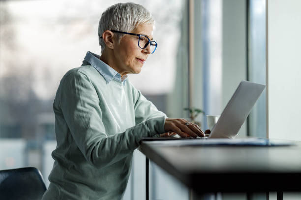 istock Senior businesswoman reading an e-mail on laptop. 1473853189