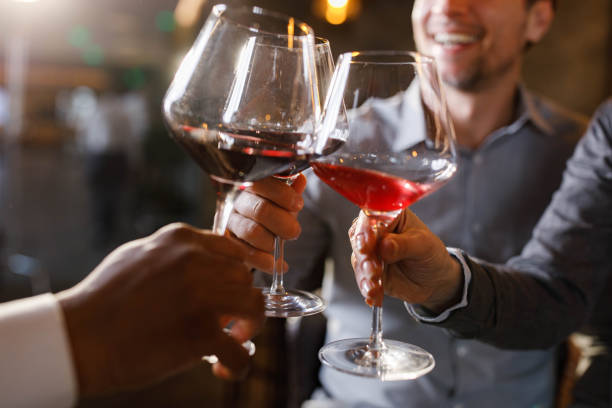 istock Close up of toasting with red wine. 1473853229