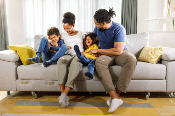 istock Happy black family having fun on sofa at home. 1473854241