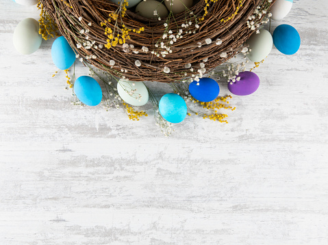 Easter wreath background with dyed eggs