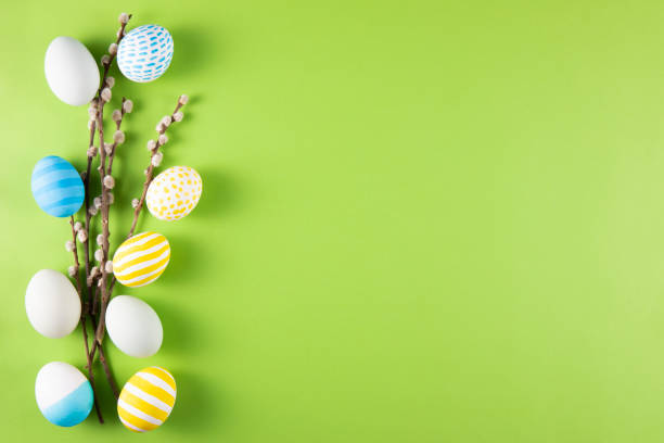 istock Flowers and Coloured Easter Eggs on Light Green Background 1473854638