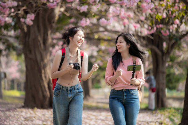 istock Two female tourists walking happily chatting. 1473856122